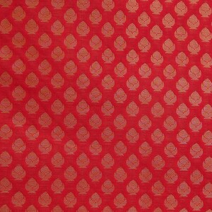 May include: A vibrant red fabric featuring a repeating pattern of small, stylized golden-yellow floral or leaf-like motifs arranged in a structured grid. The design consists of symmetrical, teardrop-shaped elements with intricate internal line details.