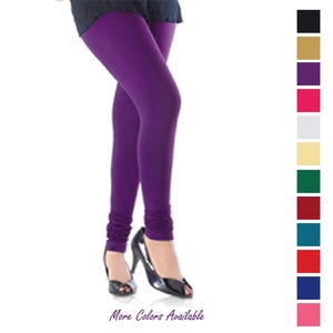 May include: Solid purple leggings featuring a fitted silhouette and gathered fabric at the ankles. A vertical color palette on the right side displays twelve additional color options, including black, gold, red, white, cream, green, and blue.
