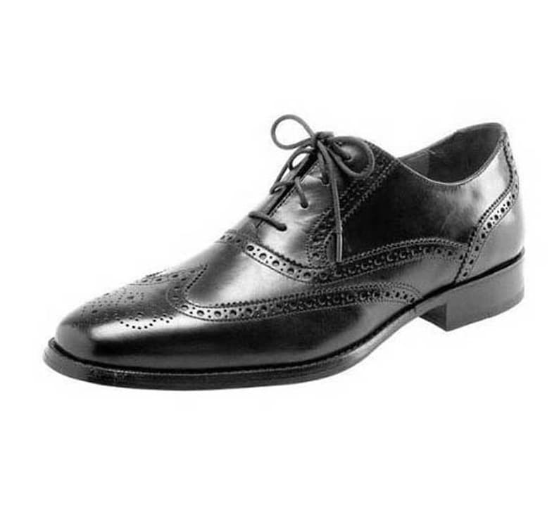 May include: A black leather oxford shoe featuring a classic wingtip design with decorative brogue perforations along the seams, a rounded toe, a low stacked heel, and thin black laces tied in a bow across the top of the vamp.