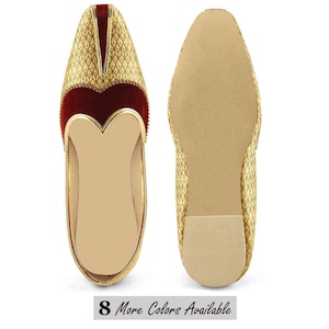 May include: Pair of gold-colored, ornate slip-on shoes with a diamond pattern. The shoes have a red velvet accent and a gold trim. The soles are a light tan color. The text "8 More Colors Available" is at the bottom.
