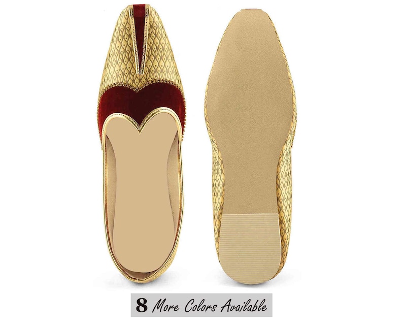 May include: Pair of gold-colored, ornate slip-on shoes with a diamond pattern. The shoes have a red velvet accent and a gold trim. The soles are a light tan color. The text "8 More Colors Available" is at the bottom.