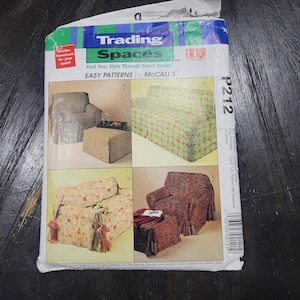 May include: A McCall's Trading Spaces sewing pattern envelope labeled P212. The front displays four photographs of furniture covered in various floral and checkered fabrics, including armchairs, a sofa, and ottomans with tie details.