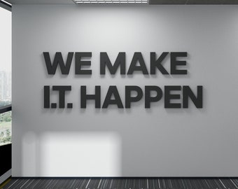 May include: An office interior featuring a white wall with the text "WE MAKE I.T. HAPPEN" in large, dark letters. The space includes a patterned carpet, windows, and a glimpse of another room.