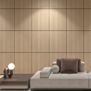 May include: A white sectional sofa with brown throw pillows sits in front of a wall with wood panelling. The sofa is on a light grey rug.