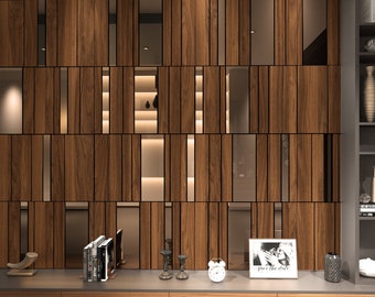 May include: A modern living room with a wooden wall unit featuring a geometric pattern of vertical and horizontal slats. The wall unit has a built-in shelf and a glass-paneled section. The wall unit is accented with a framed photo with the text "you the whole" and a clock. The wall unit is flanked by a bookshelf with various decorative items.