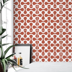 White Tile Stickers with terracotta hourglass shapes on a bathroom wall.