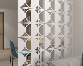 May include: White geometric room divider with a repeating pattern of squares and semi-circles. The divider creates a visual separation in the room, with a glimpse of a desk, chair, and bookshelf visible through the cutouts. The design adds a modern touch to the interior.