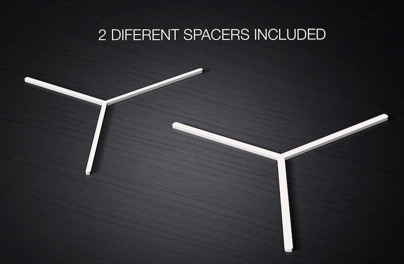 May include: Two white plastic spacers, shaped like a Y, are shown on a dark wood surface. The text "2 DIFFERENT SPACERS INCLUDED" is above the spacers.