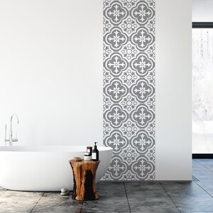 May include: A vertical strip of wall tiles featuring a repeating grey and white quatrefoil pattern. The tiles are arranged in a single column, displaying a symmetrical floral-inspired design with intricate geometric lines and rounded edges.