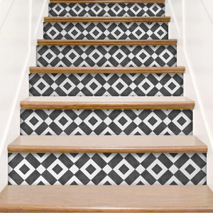 May include: A staircase featuring decorative riser decals with a repeating black and white geometric pattern. The design consists of alternating squares and diamonds, applied to the vertical faces of each step between the wooden treads.