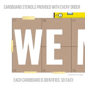 May include: Cardboard stencils with the letters "WE" cut out, taped together. A yellow level rests on top. Text reads "Cardboard stencils provided with every order" and "Each cardboard is identified. So easy."