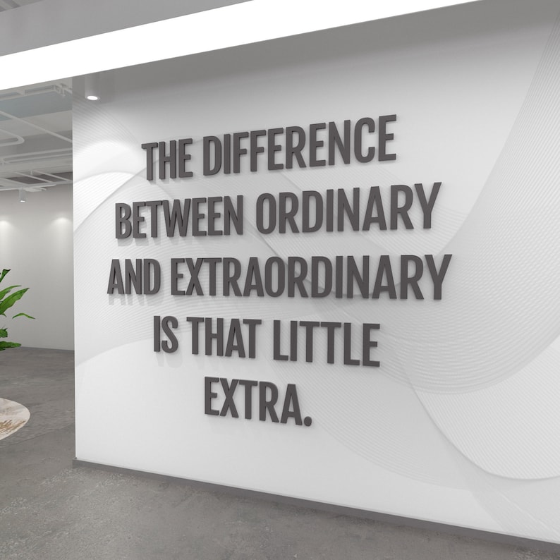 Quote 3D Wall Decor: The difference between ordinary and extraordinary is that little extra, in the dark grey color option on a white wall in a company hallway.