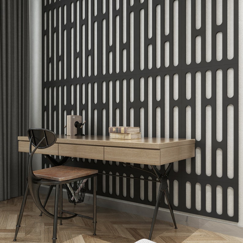 May include: A modern home office setup featuring a light wood desk with three drawers, a black metal chair with a brown seat, and a decorative black wall panel. Books and a desk organizer sit on the desk. The room has hardwood floors and a dark curtain.