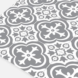 May include: A series of square tiles arranged in a grid pattern, each featuring a repeating gray and white floral-inspired quatrefoil motif. The design consists of symmetrical, curved shapes and petal-like elements centered on each individual tile.
