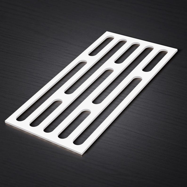 May include: A white rectangular panel with a series of evenly spaced, elongated cutouts. The panel is positioned diagonally, showcasing its clean lines and minimalist design. The background is a dark, textured surface.