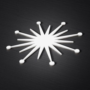 May include: A white, starburst-shaped design with 12 points, each ending in a small circle. The design is on a dark grey background.