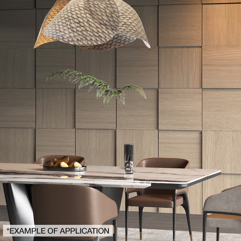 May include: A modern dining room setting featuring a rectangular marble-topped table with brown leather chairs. A decorative light fixture hangs above, and a wall with square wooden panels forms the backdrop. A vase with a plant and a bowl with fruit are on the table.