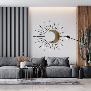 3D Wall Decor: Golden acrylic half moon, with black sticker vinyl sun rays around it, on a white wall in a living room.