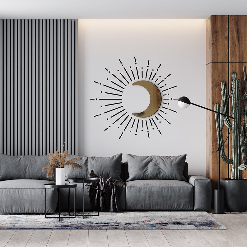 3D Wall Decor: Golden acrylic half moon, with black sticker vinyl sun rays around it, on a white wall in a living room.