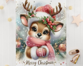 May include: A cute cartoon reindeer wearing a pink hat, scarf, and a holly wreath with red berries. The reindeer is holding a red and white Christmas bauble. The background is white with snowflakes and the text "Merry Christmas".