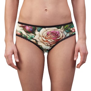 May include: Black and white floral print underwear with a large rose in the center. The rose is pink, white, and yellow with green leaves.