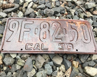 May include: A rusty metal license plate with the number 9F-8250 and the text "CAL 30".