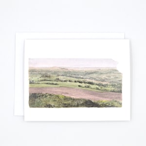 May include: Watercolour painting of a landscape with rolling hills and fields. The painting is done in shades of green, brown, and grey.