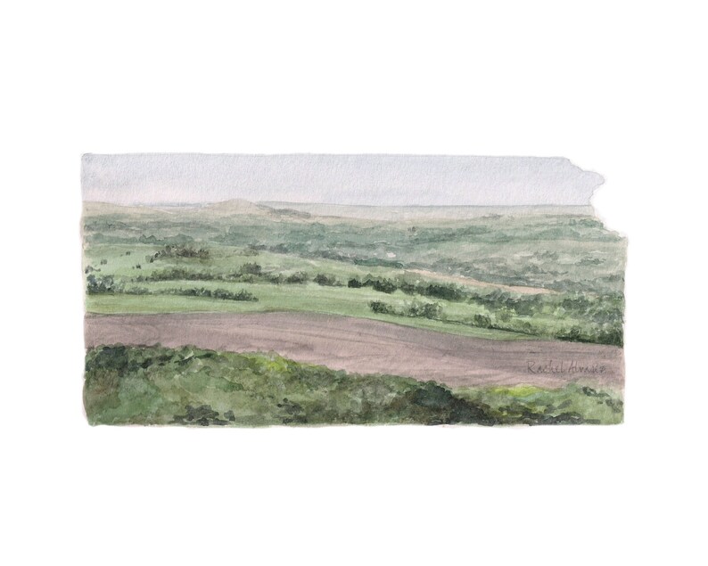 May include: Watercolour painting of a rolling green landscape with a brown field in the foreground. The sky is a light blue with a few clouds. The painting is signed "Rachel Himes" in the bottom right corner.