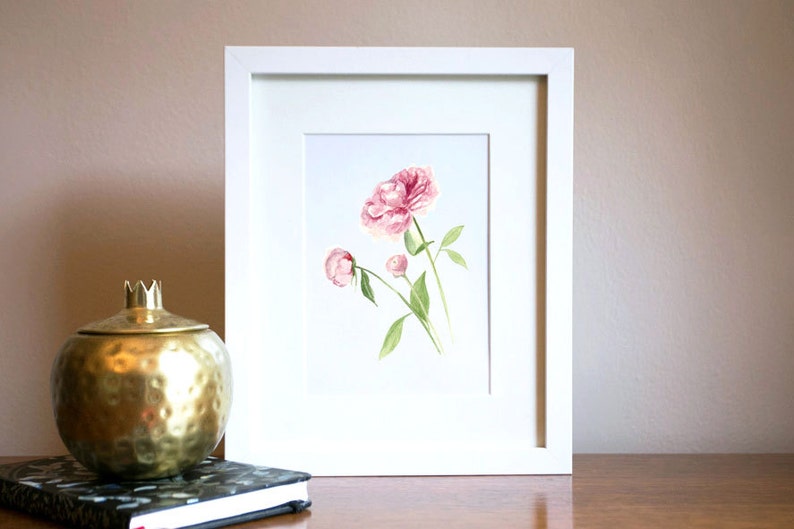 May include: A framed watercolour painting of pink peonies with green stems and leaves.