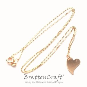 May include: A gold chain necklace with a small, brushed gold heart pendant. The chain is a delicate, box style chain.