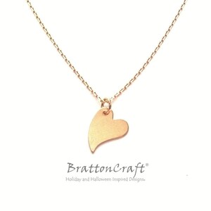 May include: A delicate gold chain necklace with a small, heart-shaped pendant. The pendant is a simple, smooth design with a slightly pointed tip.