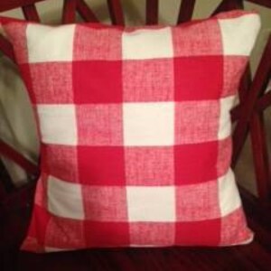 May include: Red and white checkered throw pillow with a soft, textured fabric.