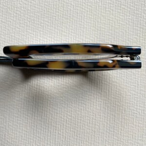 May include: A pair of tortoiseshell eyeglasses with a spring hinge.