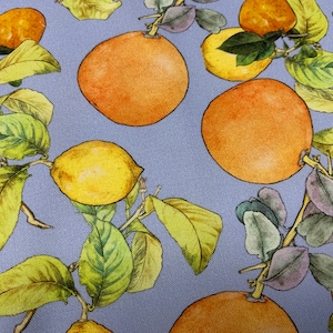 May include: A blue background with a repeating pattern of lemons and oranges. The lemons are yellow and the oranges are orange. The leaves are green and there are some purple leaves.
