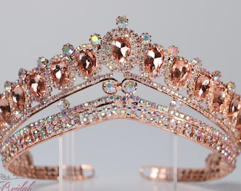 May include: A rose gold tiara with a double row of sparkling rhinestones and large, teardrop-shaped crystals.
