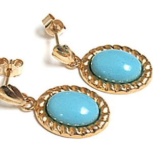 May include: A pair of gold earrings with turquoise blue oval stones set in a rope-like design.
