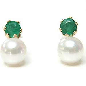 May include: A pair of gold earrings with a green emerald gemstone and a white pearl.