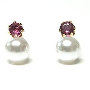 May include: A pair of earrings featuring a small pink gemstone and a white pearl on each earring.