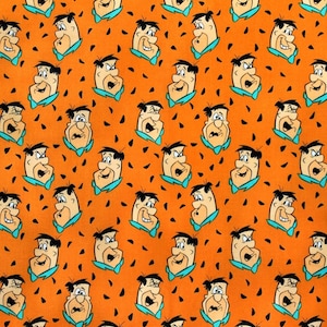 May include: Orange fabric with a repeating pattern of cartoon faces. The faces are of a man with black hair, a blue bow tie, and a surprised expression. The background is orange with black spots.