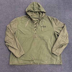 May include: A green hooded jacket with a lace-up front and the text "U.S.N." embroidered on the chest.