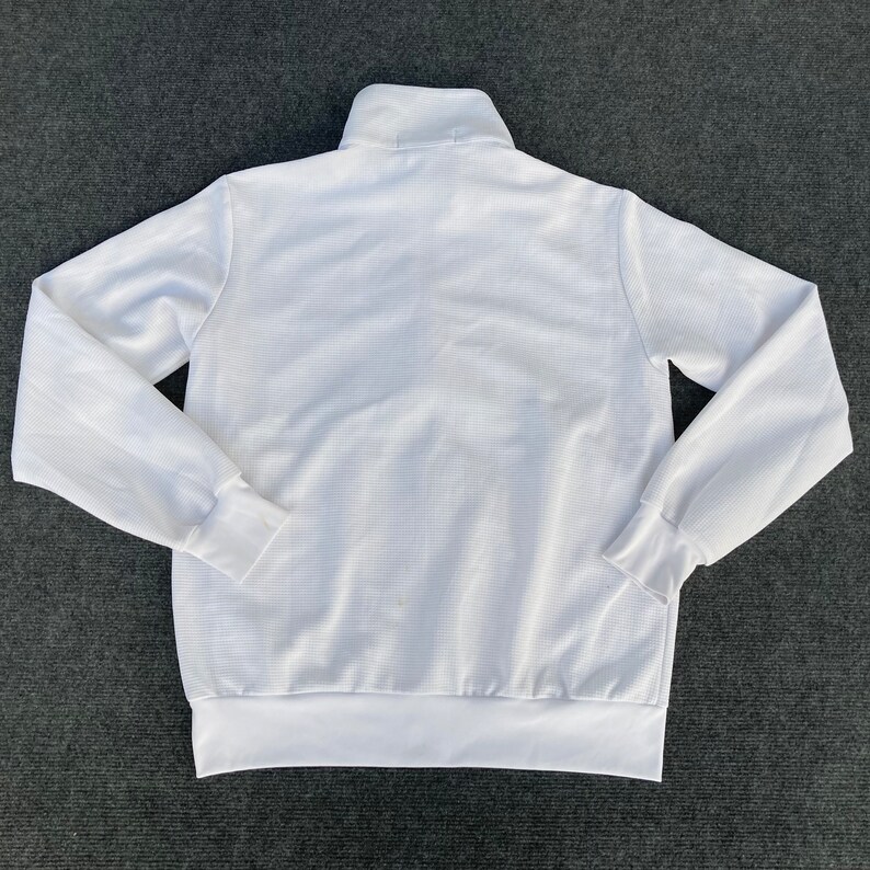 May include: White long-sleeve zippered sweatshirt with a mock neck.