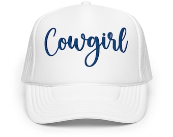 May include: White trucker hat with a blue embroidered cursive word "Cowgirl" on the front.