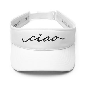 May include: White visor with the word "ciao" embroidered in black script. The visor has a curved brim and an adjustable strap. The text includes a small heart above the letter "a".
