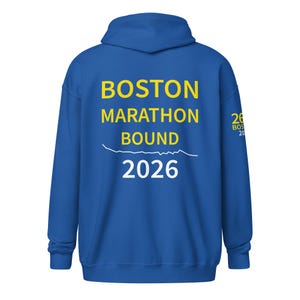 May include: A royal blue hoodie with the text "BOSTON MARATHON BOUND 2026" in yellow and white. The hoodie has a hood and long sleeves. The text is centered on the back.