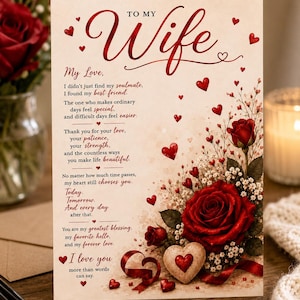 May include: A greeting card with a cream background featuring the text To My Wife and a romantic poem. The design includes illustrations of deep red roses, small white flowers, red hearts, and a heart-shaped stone with a red heart accent.