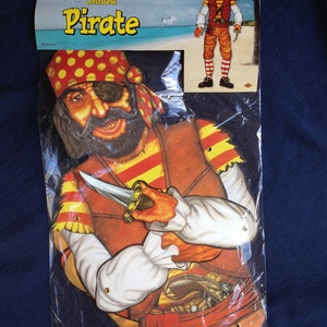 May include: A jointed pirate decoration in a plastic package. The pirate has a red and yellow bandana, an eye patch, and a brown vest. He is holding a dagger. The package reads "Jointed Pirate" and shows a smaller image of the pirate.