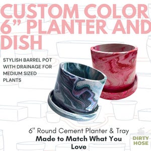 May include: Two 6-inch round cement planters with matching trays, featuring a marbled finish. One planter displays a dark blue, black, and white swirl pattern, while the other features a vibrant red, pink, and white marbled design with drainage.