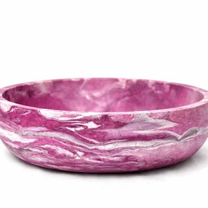 May include: A round bowl featuring a vibrant magenta and white marbled pattern throughout its surface. The bowl has a smooth, curved exterior and a wide, open top, showcasing a swirling, fluid design that blends deep pink tones with bright white.