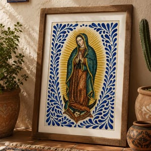 May include: A framed print of a religious figure with a blue and yellow halo and blue floral border. The artwork is in a wooden frame and leans against a wall. The image is in a room with a rug, plants, and decorative pottery.