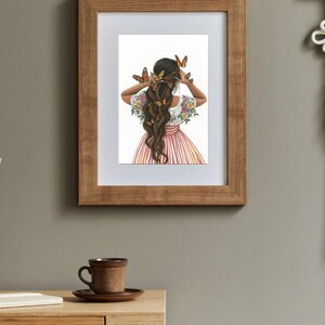 May include: A framed illustration of a woman with long brown hair decorated with butterflies. She is wearing a pink and white striped dress with floral embroidery on the sleeves. The background is white.